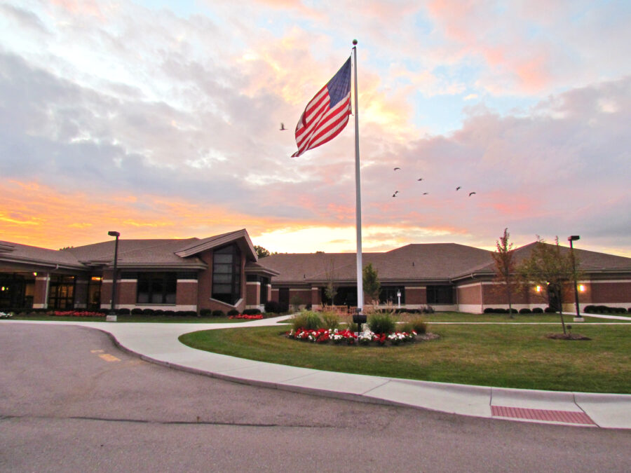 Picture of the Angela Hospice Care Center in early morning with a flag waving out front.