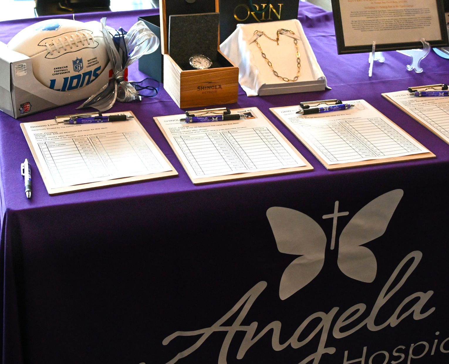 Auction featuring an autographed football, shinola watch, and gold necklace