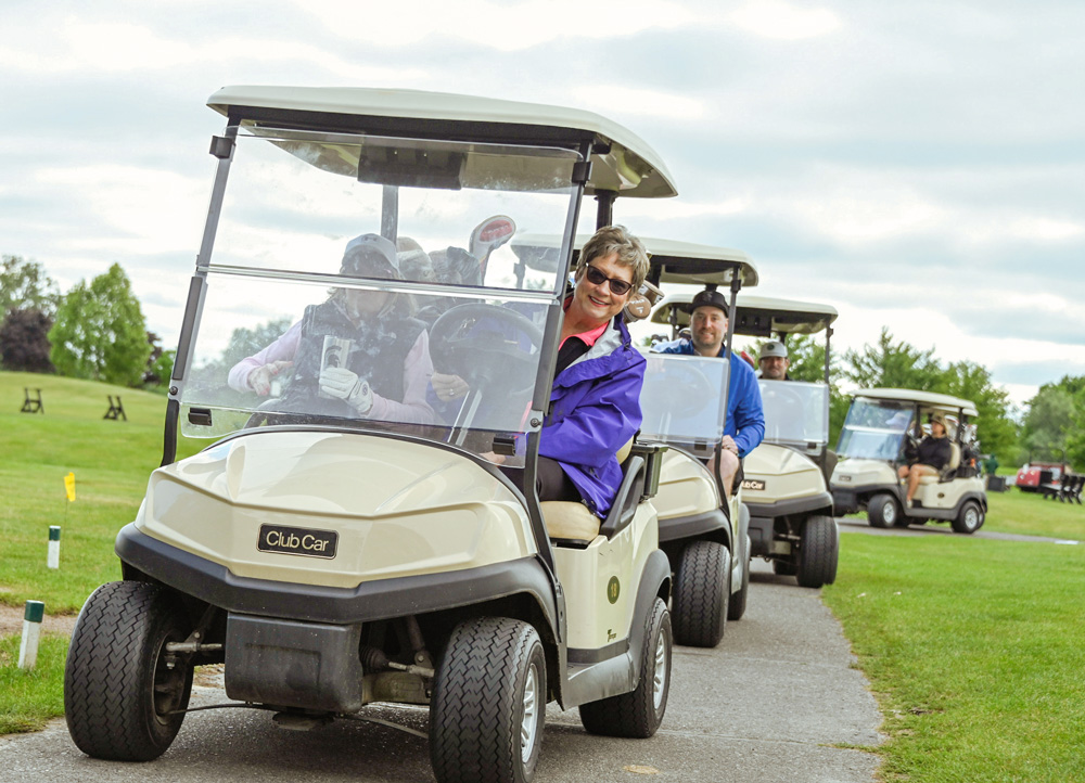 a group of people in golf carts