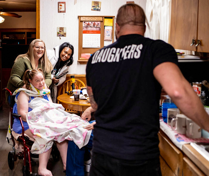 Sarah, Dominique, and a friend look on as Crazzy Steve enters.