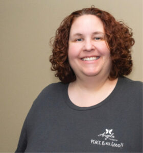 a woman smiling wearing an Angela Hospice shirt