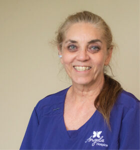 hospice aide in a purple scrub top