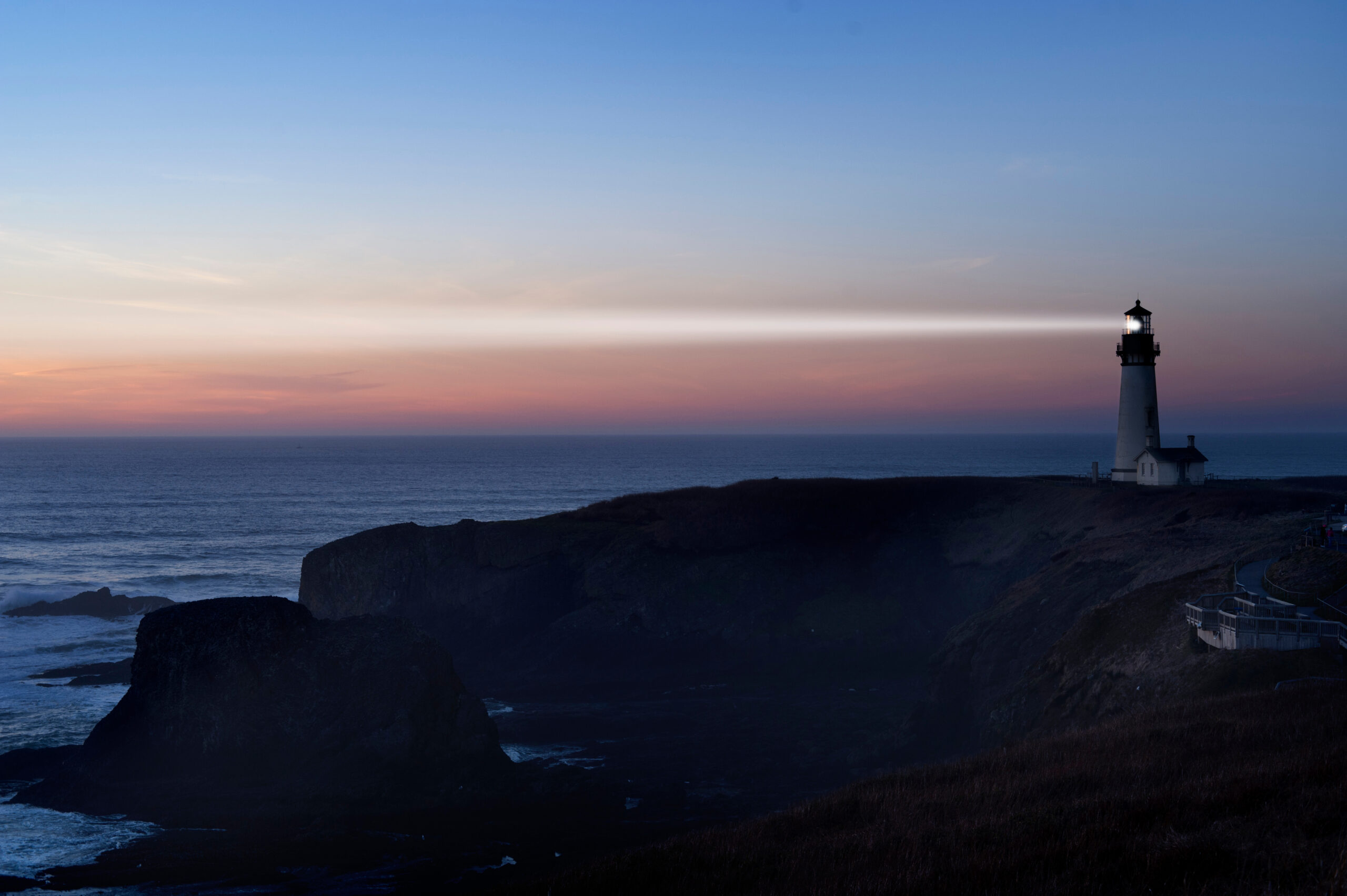 Lighthouse and beam at dusk