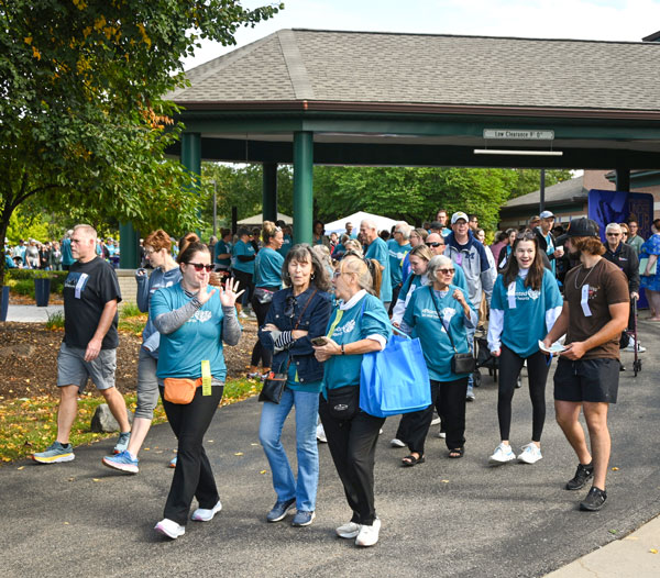 a large grouip of walkers walking at Angela Hospice